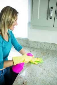 Pretty woman doing her house chores at home